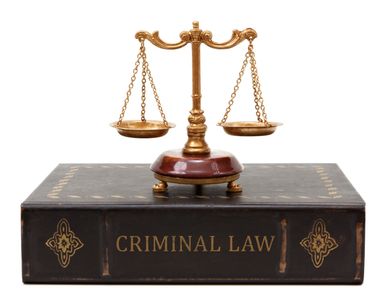 Scale balance on a criminal law book.