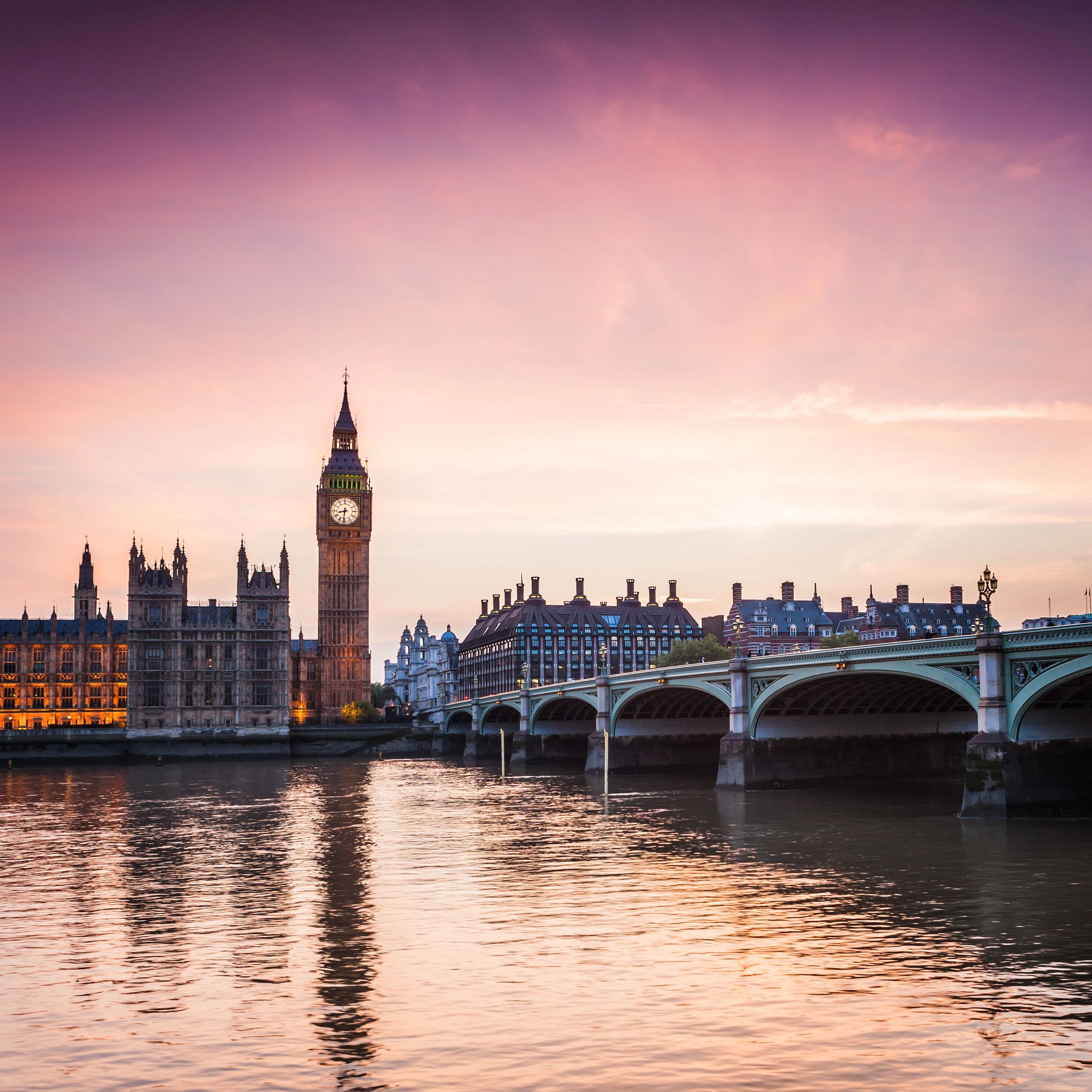 Big Ben and Westminster Bridge at sunset in London.