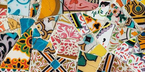 Colorful mosaic made of broken ceramic tiles with various patterns.