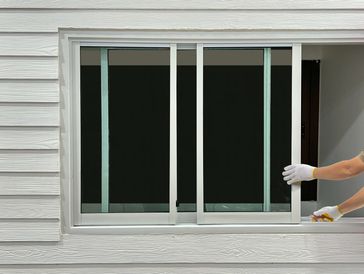 Close-up of worker installing window