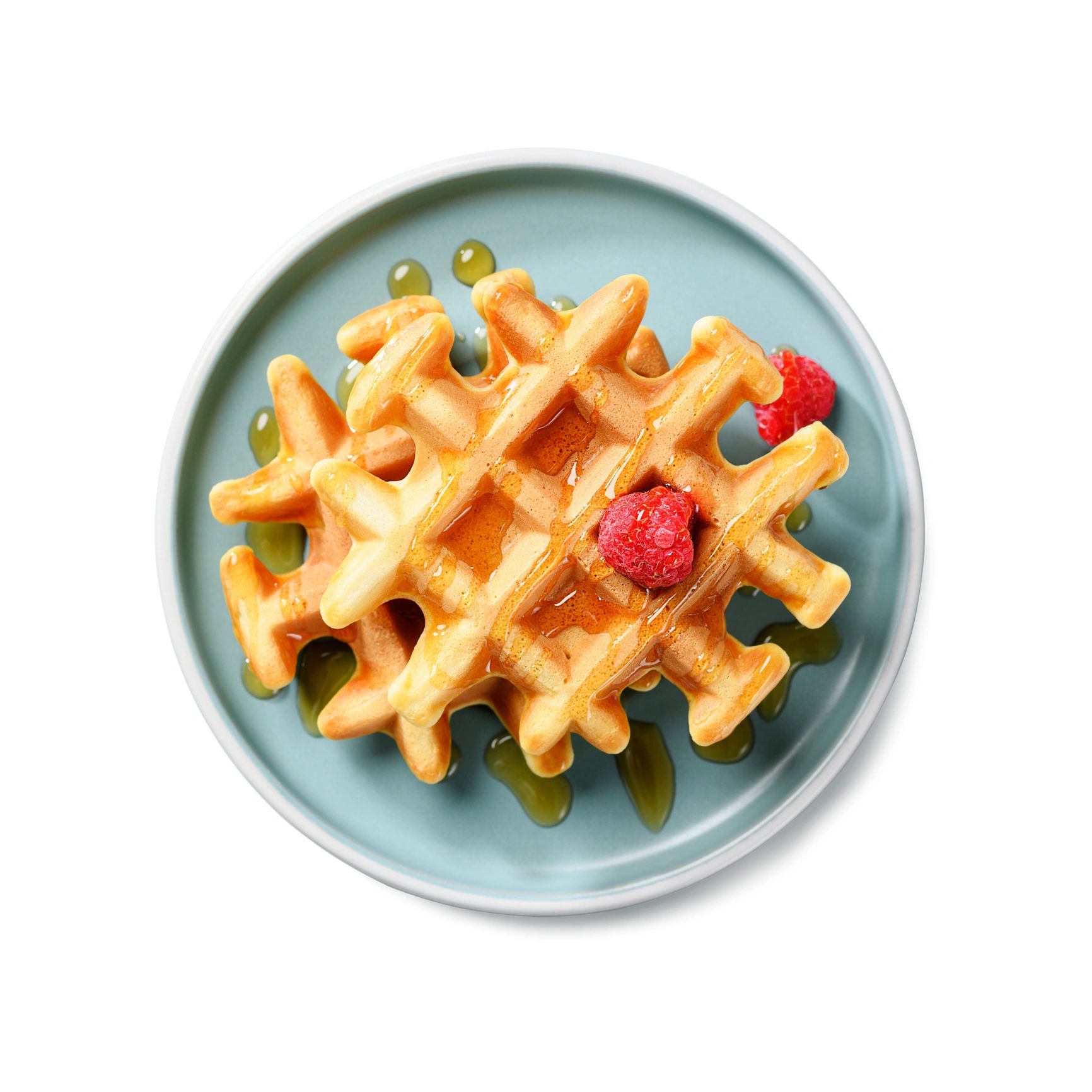 Stack of waffles with syrup and raspberries on a blue plate.