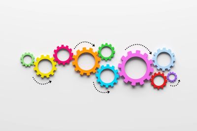 Colorful interconnected gears symbolizing teamwork and process.