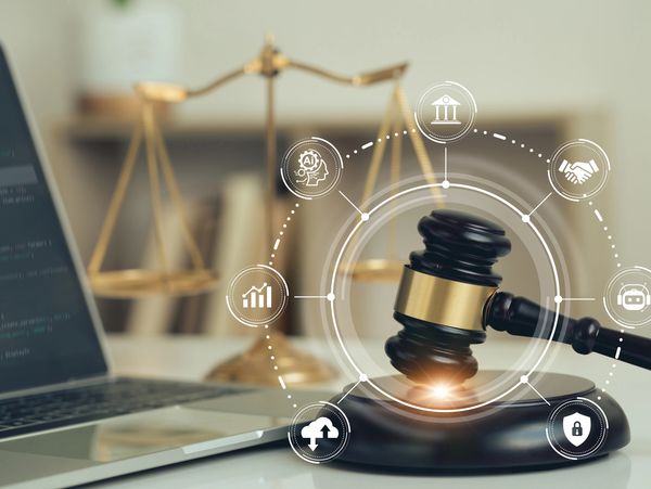 A judge's gavel, scales of justice, and laptop with legal and tech icons overlay.