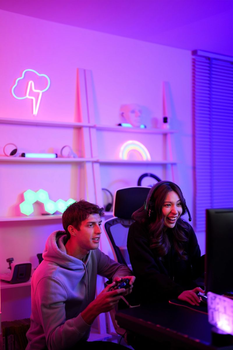 Couple streamer lover boy and girl use joystick for playing video game together hobby in the weekend at entertainment violet neon light room vertical style