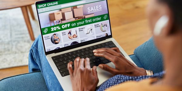 Person shopping online with 20% off offer visible.