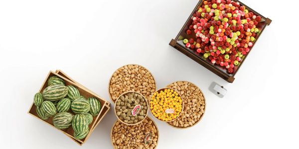 Top view of assorted fruits and nuts in wooden containers on white background.