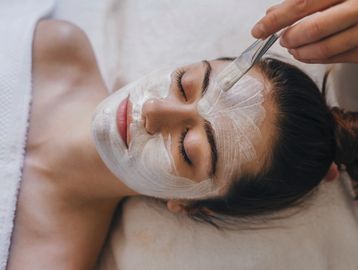 Woman relaxing while receiving a facial in Everett, WA at Autumn Noel Esthetics.