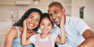 Happy family smiling together at home.