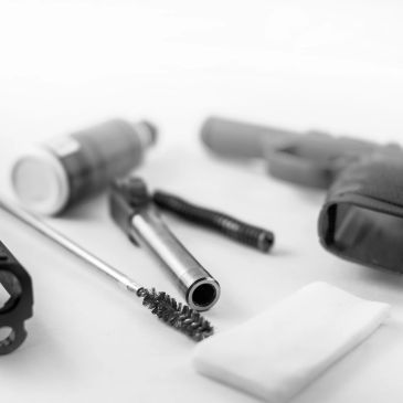 Gun cleaning tools and parts laid out.