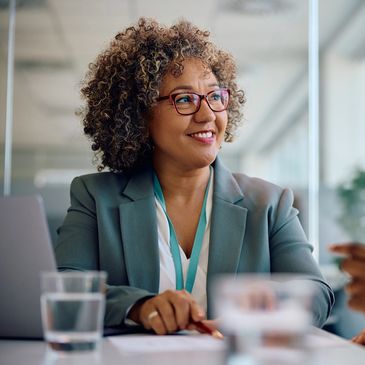 Confident business woman smiling during a meeting with colleagues.
