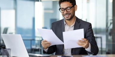 Man reviewing documents at his desk.