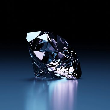 A sparkling diamond reflecting light on a smooth surface.