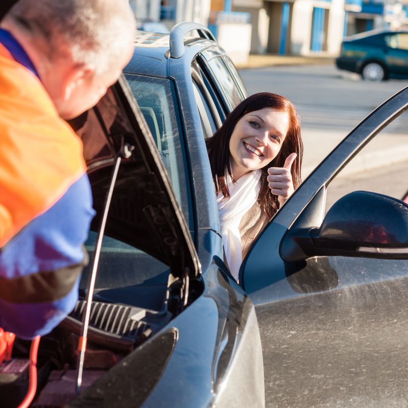 Mechanic fixing car happy woman thumb up  breakdown problem