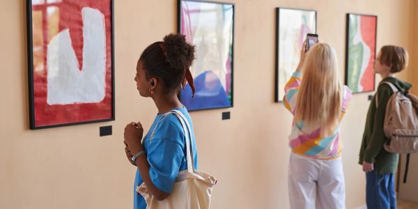 People viewing abstract art in a gallery.
