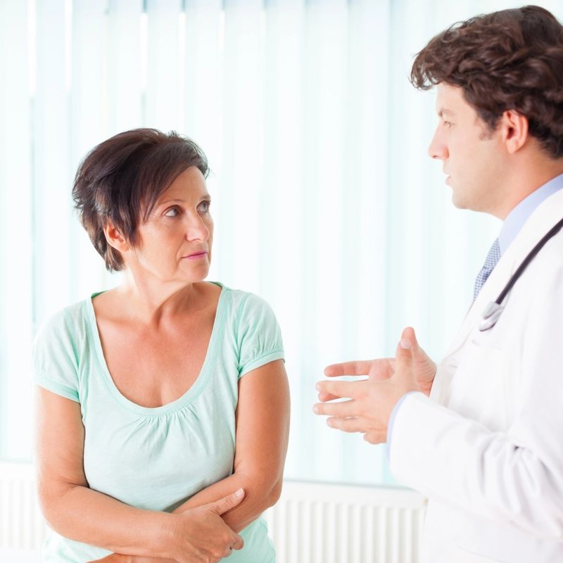 Male doctor communicate to mature woman
