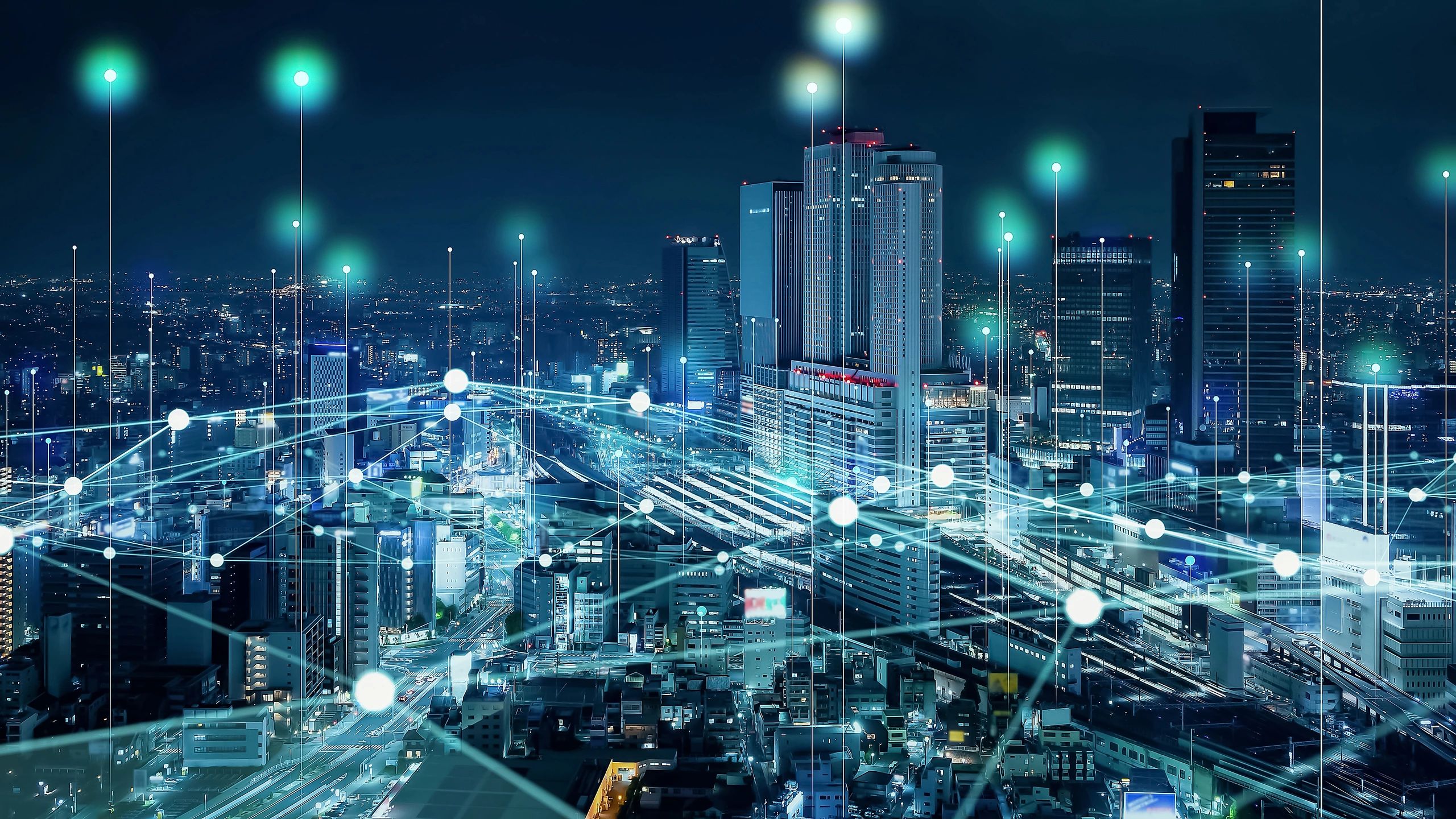 Smart city at night with digital connectivity overlays.