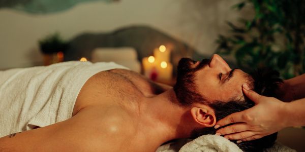 Man receiving a head massage in a spa.
