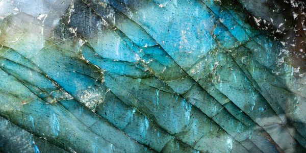 Close-up of a blue and green textured mineral or crystal surface.