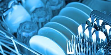 Clean dishes and utensils drying in a rack.