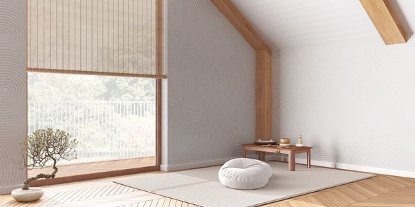 Minimalist meditation room with natural light and wooden accents.