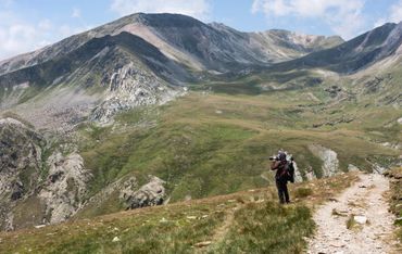 Photographer hiking in the mountains
