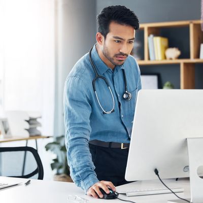 Doctor working on a computer in an office.