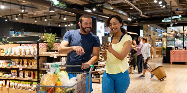Happy couple shopping together in a grocery store.