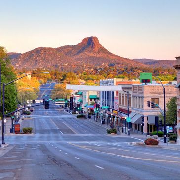 Quiet downtown street with mountain view during early morning light.