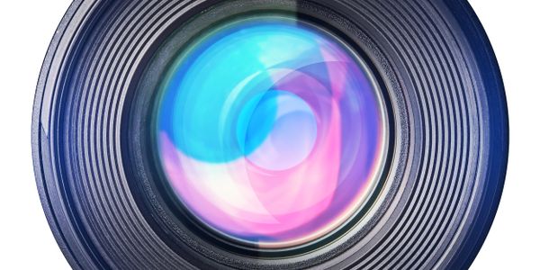 Close-up of a camera lens with colorful reflections.