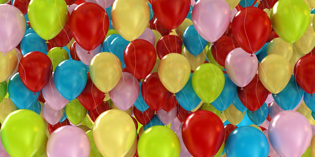 Colorful balloon decorations and a banner celebrating Kendle's 15th birthday with sponsors listed.