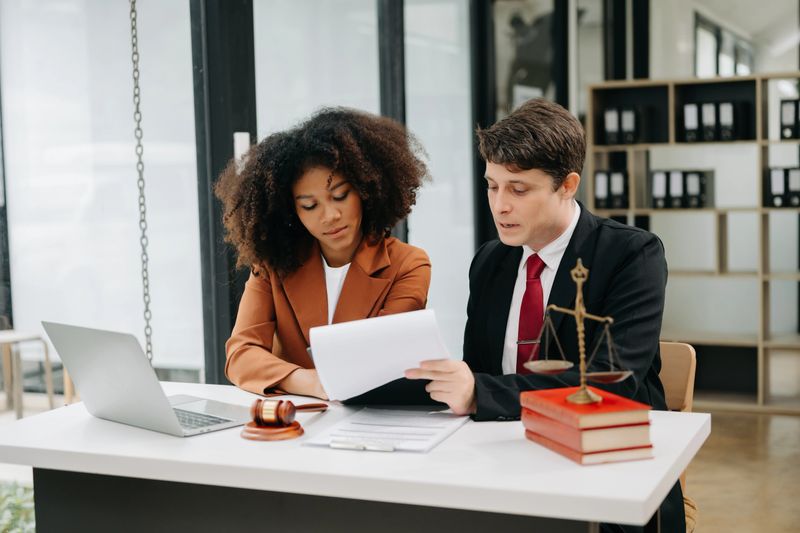 portrait of business people and lawyers discussing contract papers sitting at the table. Concepts of law, advice, legal services. in morning light