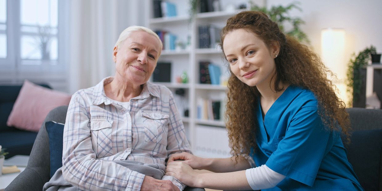 Home health aide providing comfort to older adult