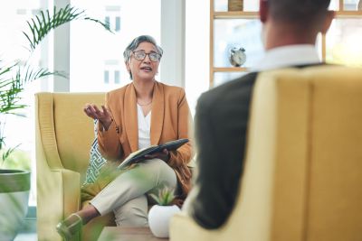 A professional woman speaking during a counseling session.