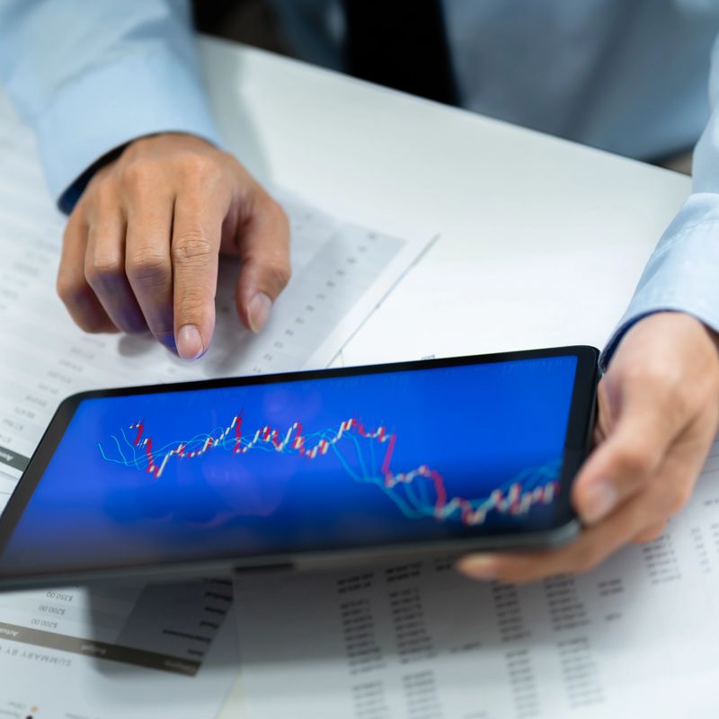 Business investor executive using laptop analyzing value of stock market exchange. Investment planing.