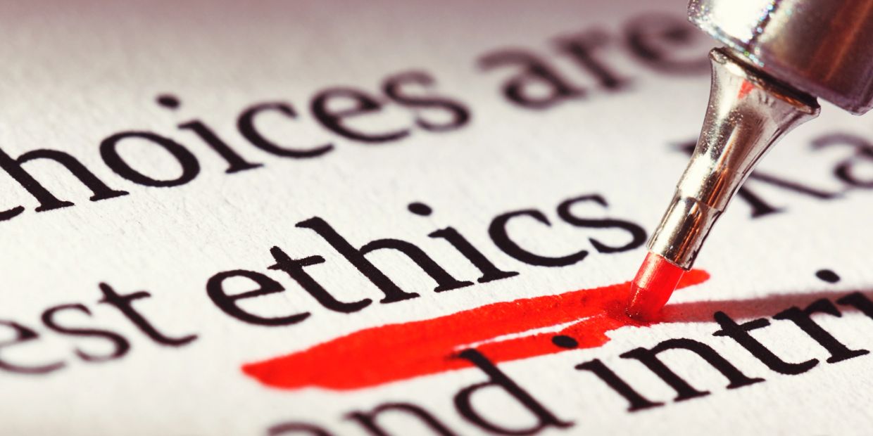 Red marker highlighting the word 'ethics' in text.