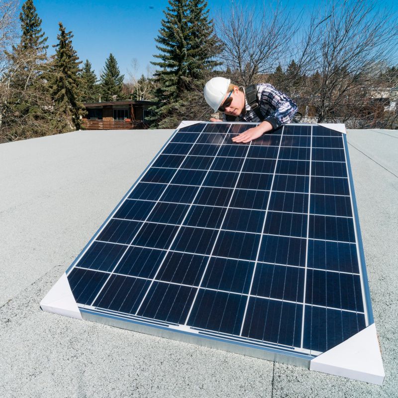 Workers inspecting solar panels before installation on a residential homes roof.