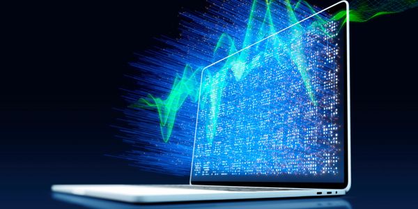 Laptop displaying dynamic digital data and waveforms.