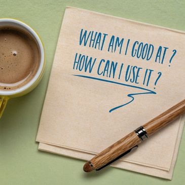 Cup of coffee next to a note asking about skills and their use with a pen.