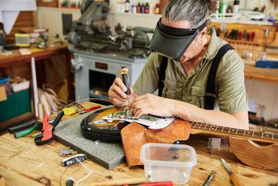 Luthier repairing a guitar