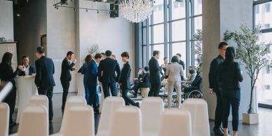 People networking at a formal event in a modern venue.