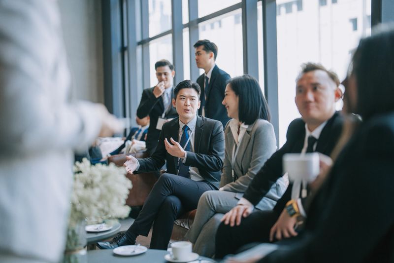 Asian Multiethnic business people talk during a coffee break in Seminar Business conference