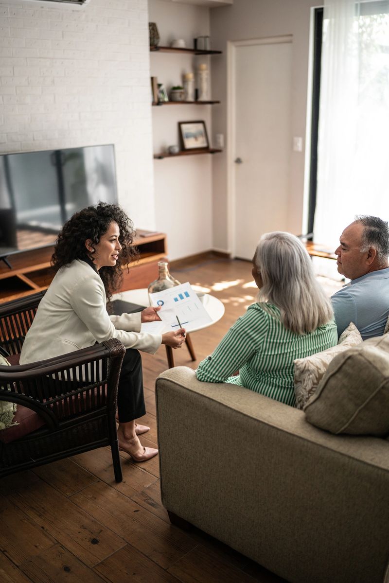 Financial advisor having a meeting with senior couple at home