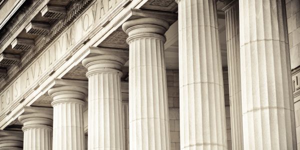 Close-up of classical stone columns at a historic building.