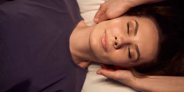 Woman receiving a relaxing facial massage.