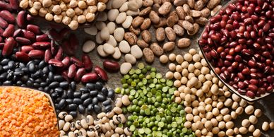 Assorted colorful dried beans and lentils arranged closely together.