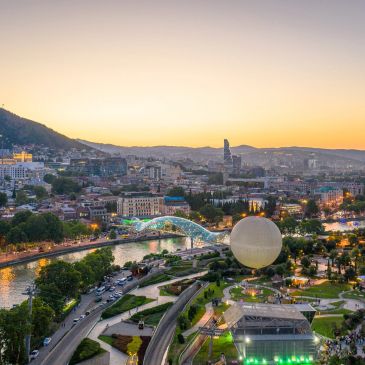Georgia Tbilisi, peace bridge and Cityscape of Tbilisi at sunset with river and modern architecture tour packages of georgia