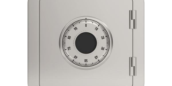 A close-up of a metal safe with a combination lock dial.