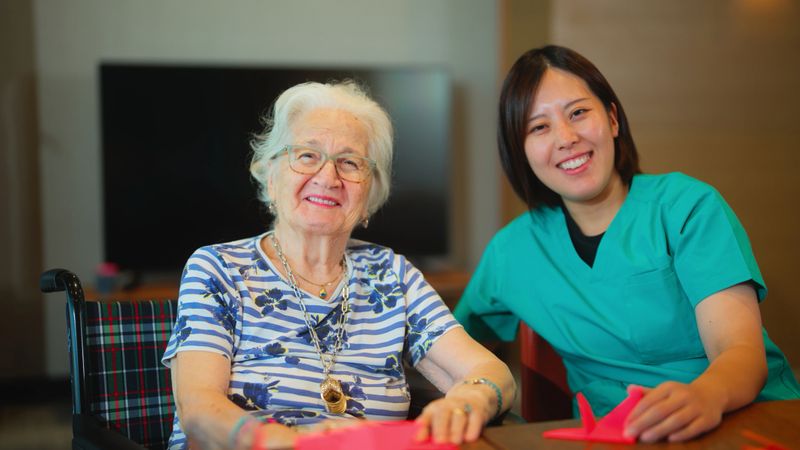 A portrait of a female nurse and a senior woman.