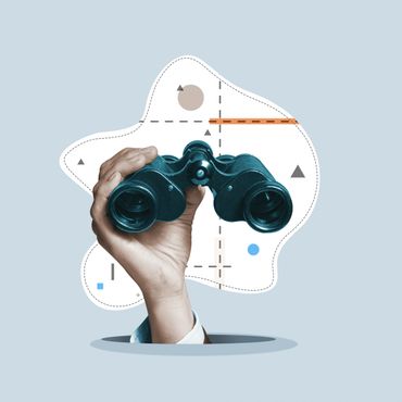 Hand holding binoculars with abstract shapes in the background.