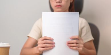 Person holding a blank notebook.